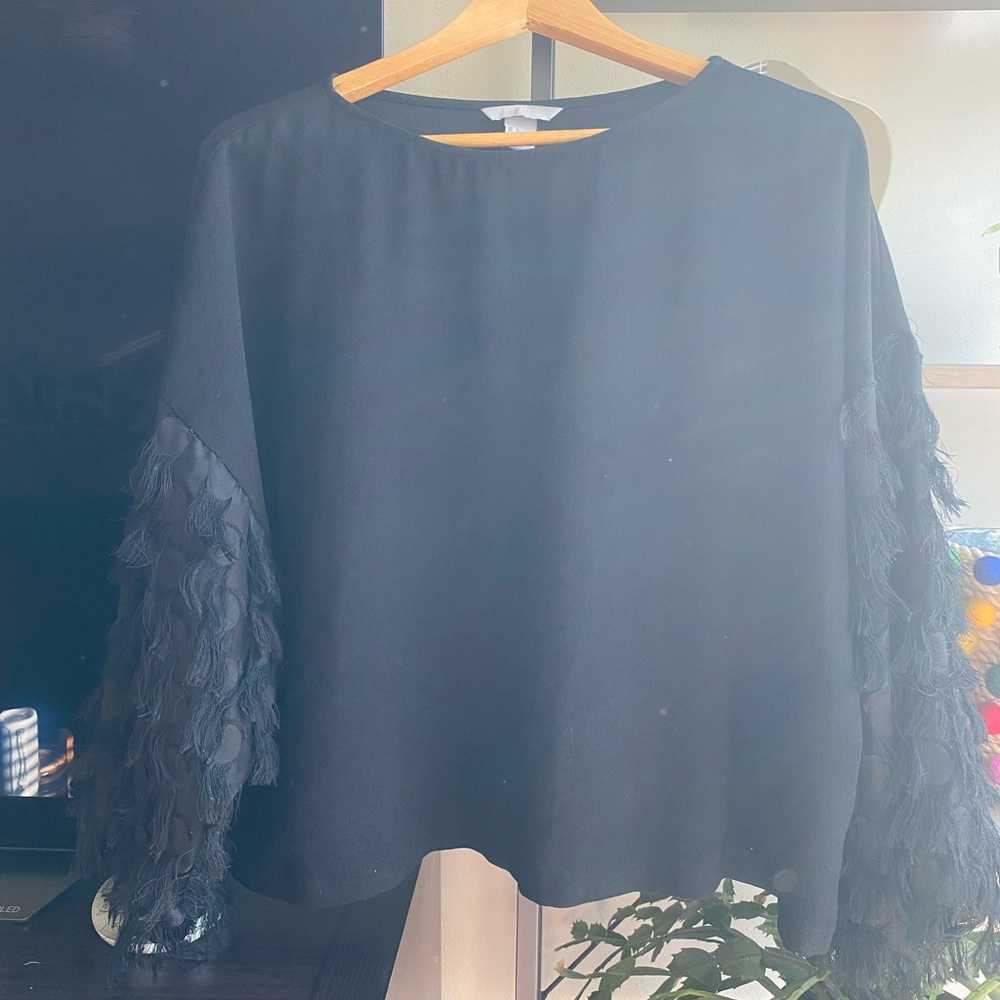 Black top with frilly sleeve details